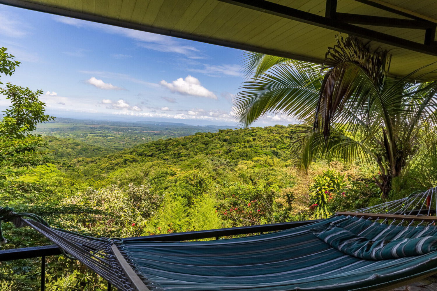 Covered terrace with a hammock overlooking the valley