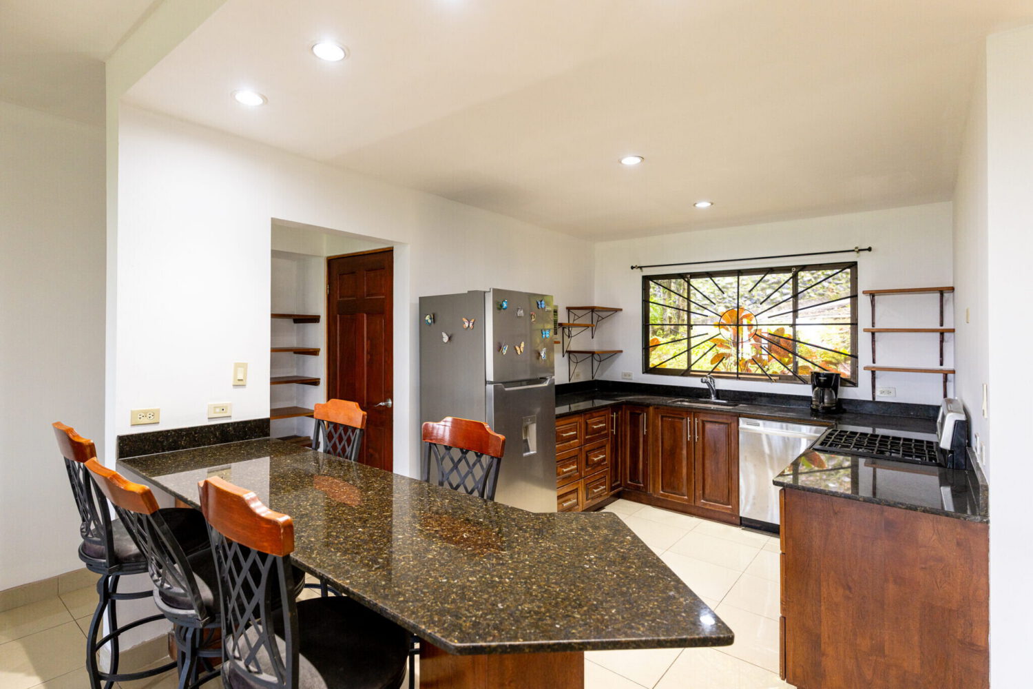 Open kitchen and dining area with a breakfast bar
