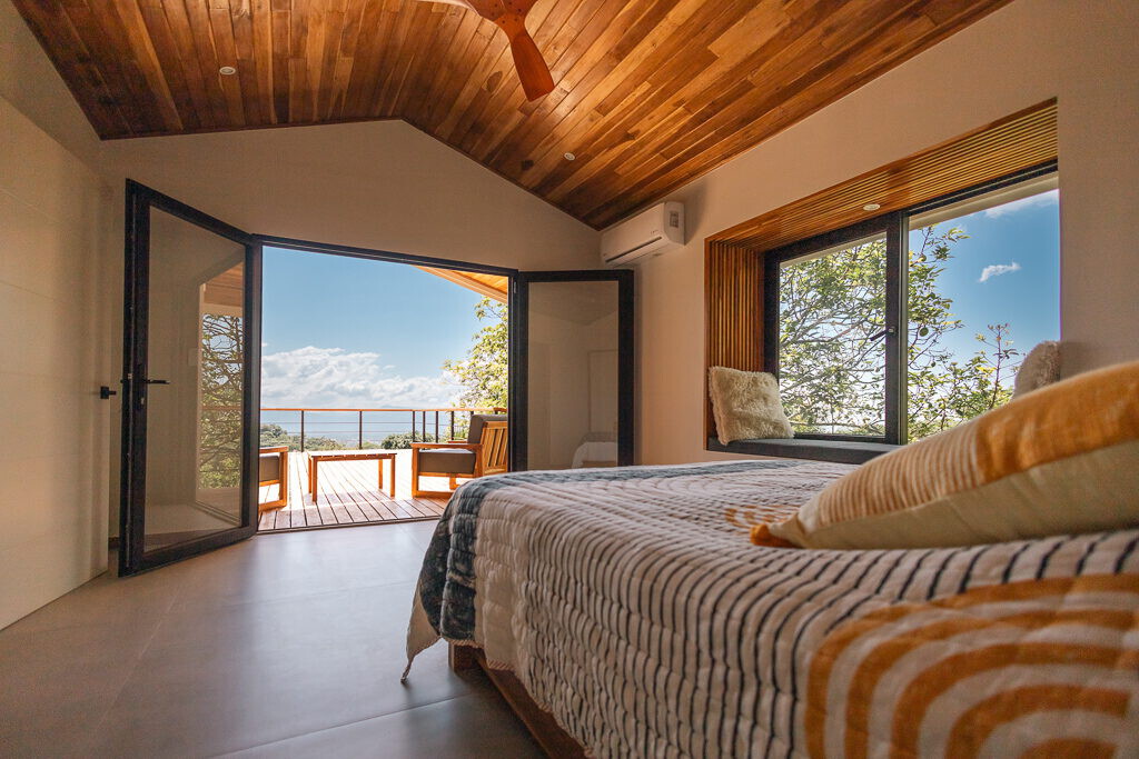 Bedroom opening through glass doors to the terrace