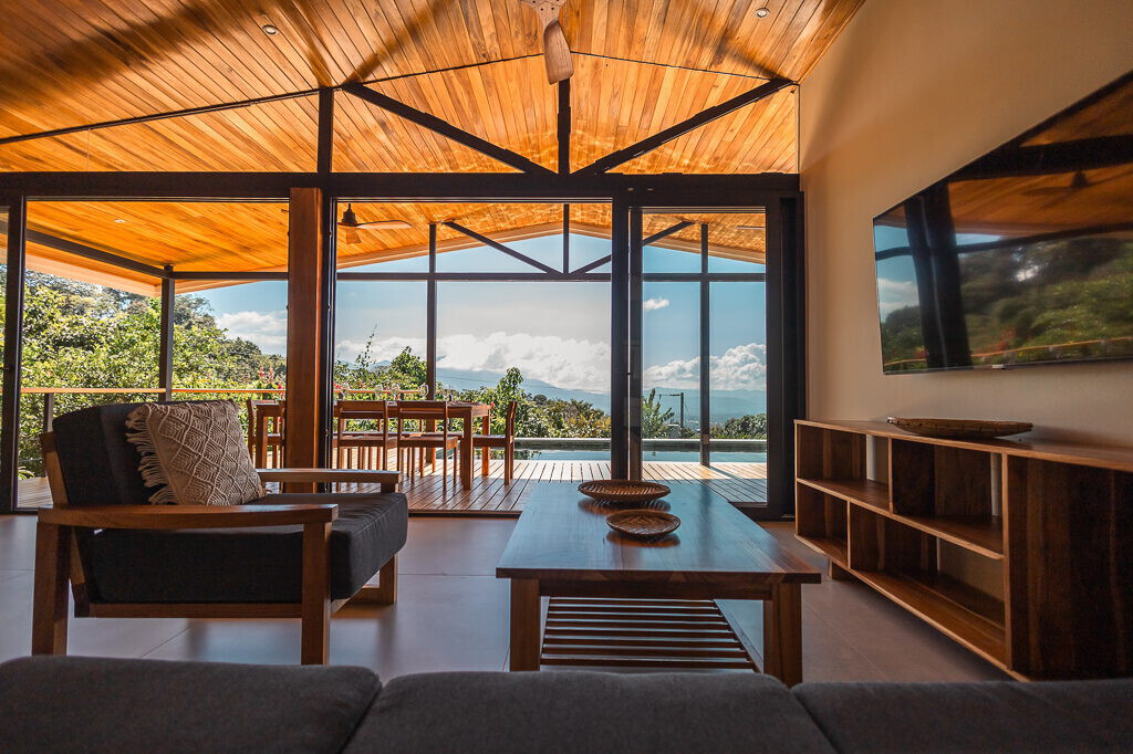 Open living room framed by glass walls onto the valley