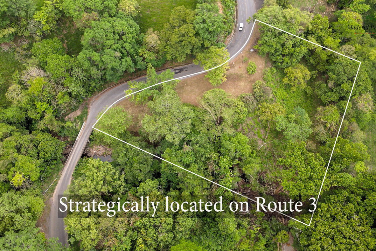 Aerial view of the lot outlined beside a curve of Route 3