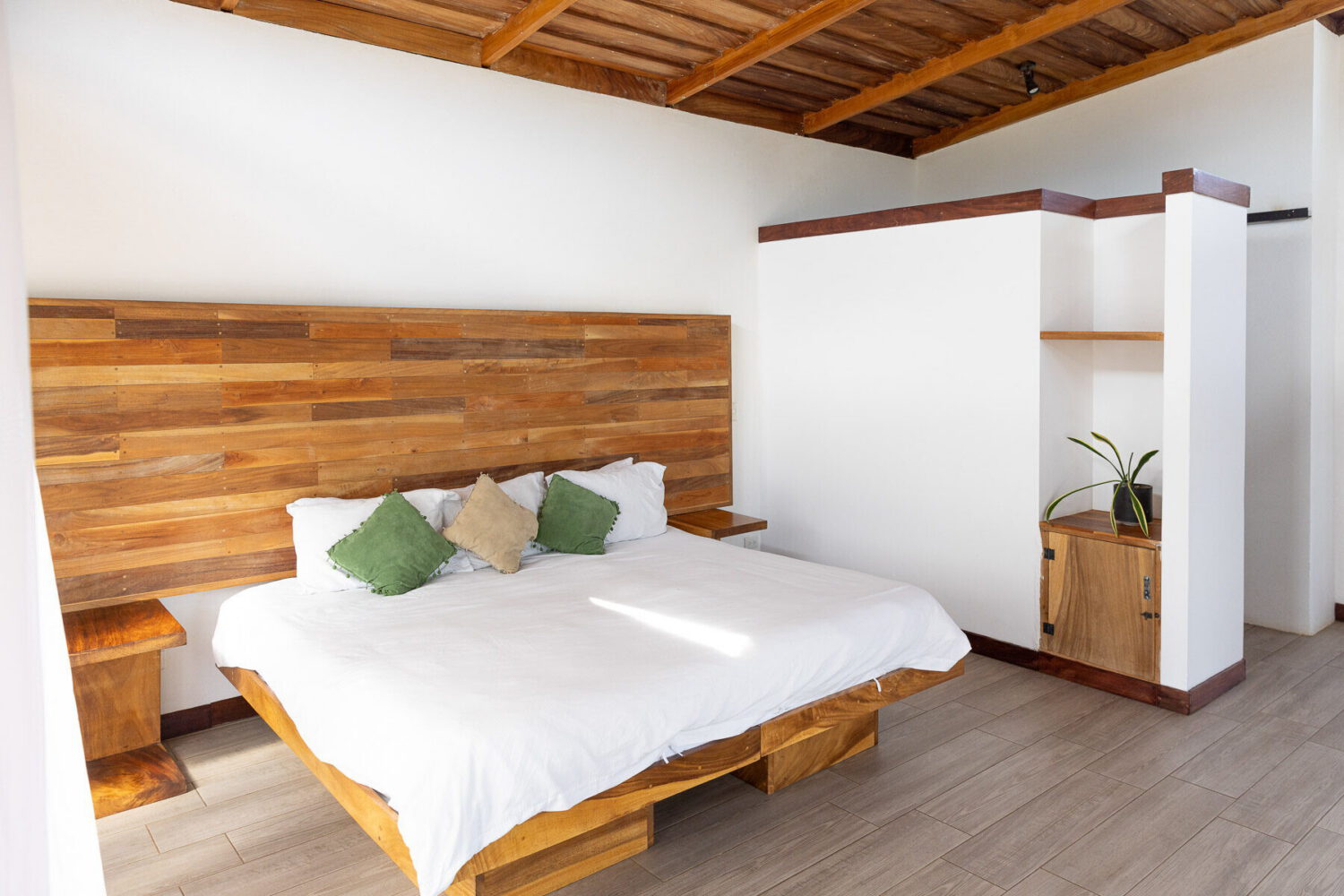 Bedroom with a full-width timber headboard wall