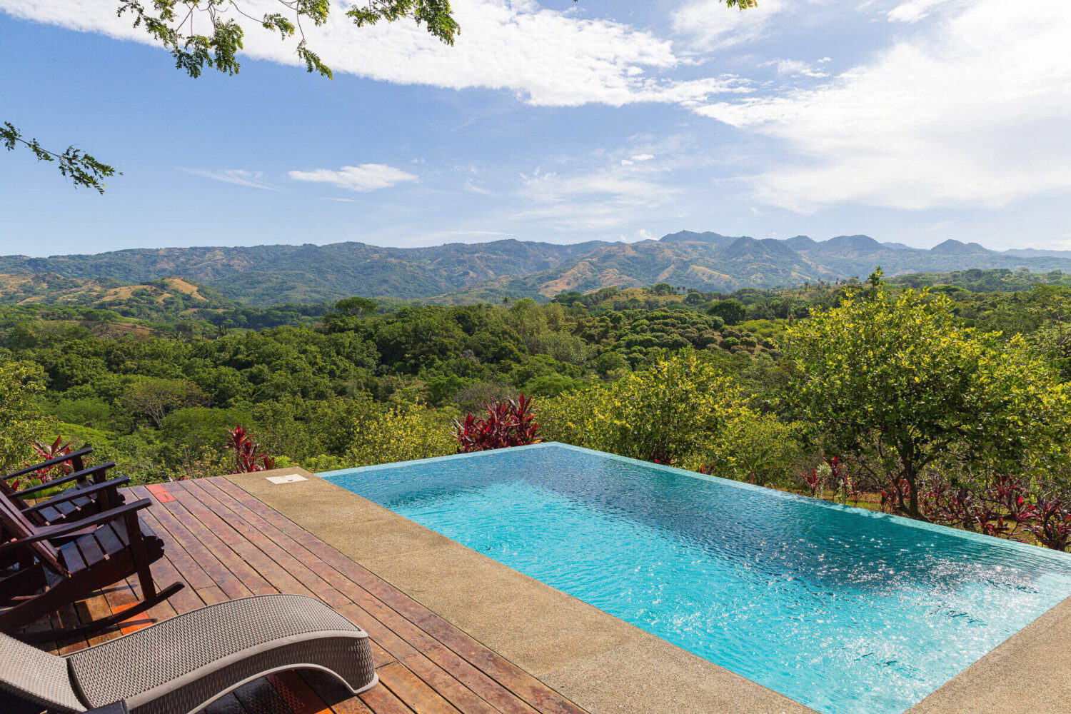 Pool and sun deck facing distant mountain ridges