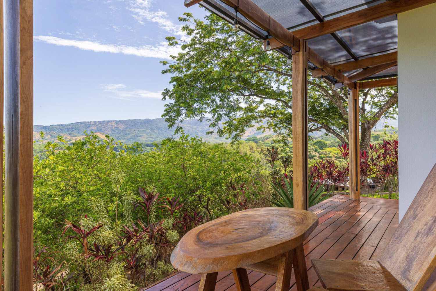 Rocking chairs on a timber deck open to the valley