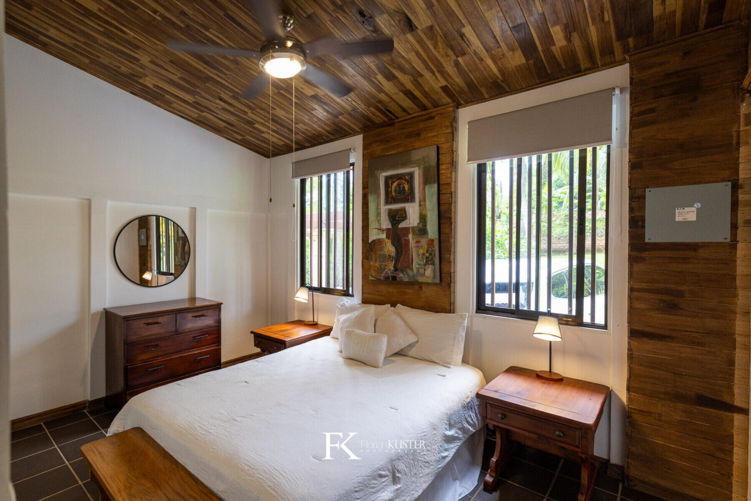Bedroom with a timber ceiling and garden window