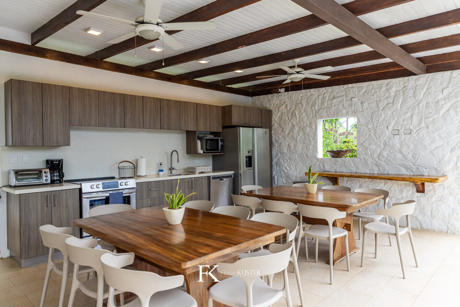 Open kitchen and dining room with a long timber table