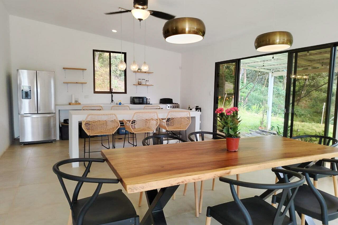 Open kitchen and dining area with floor-to-ceiling glass