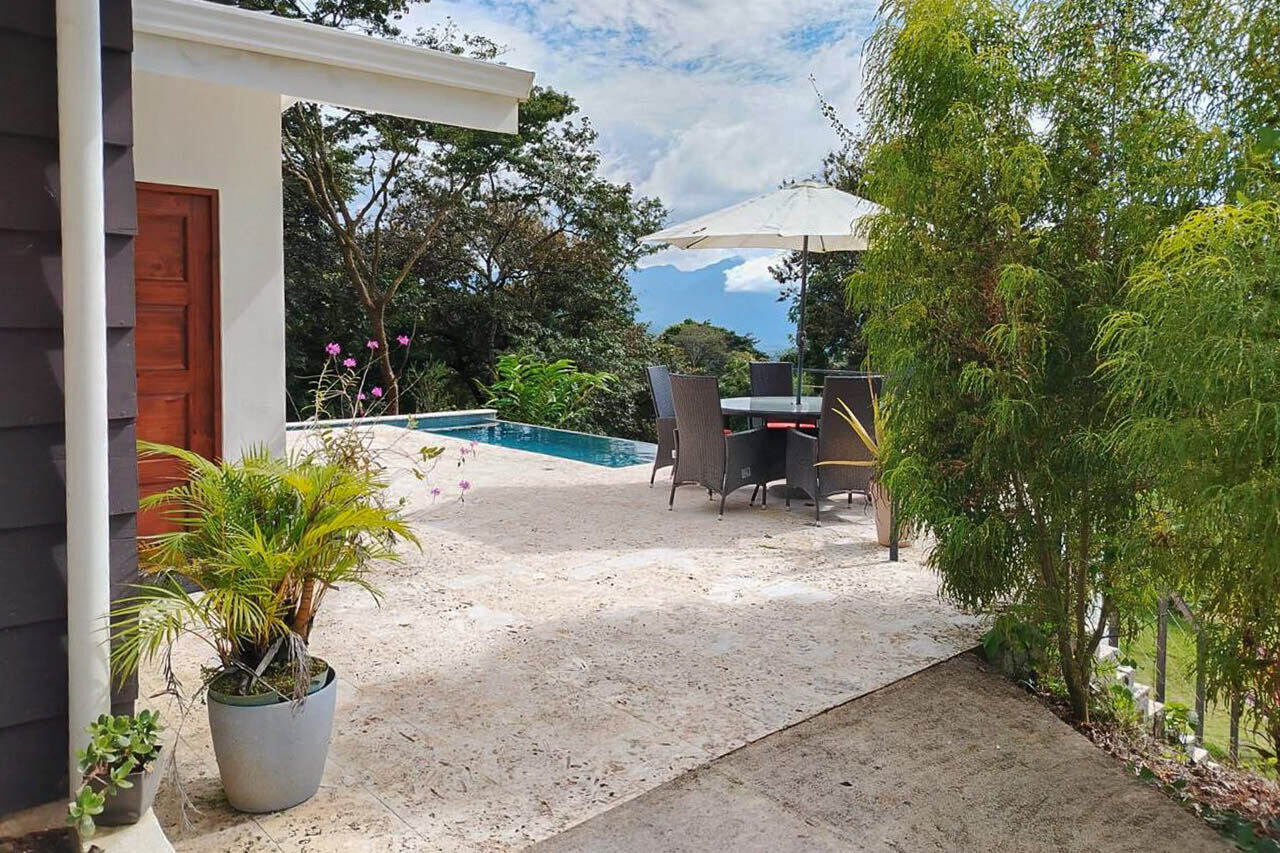 Stone pool terrace with lounge seating and mountain views