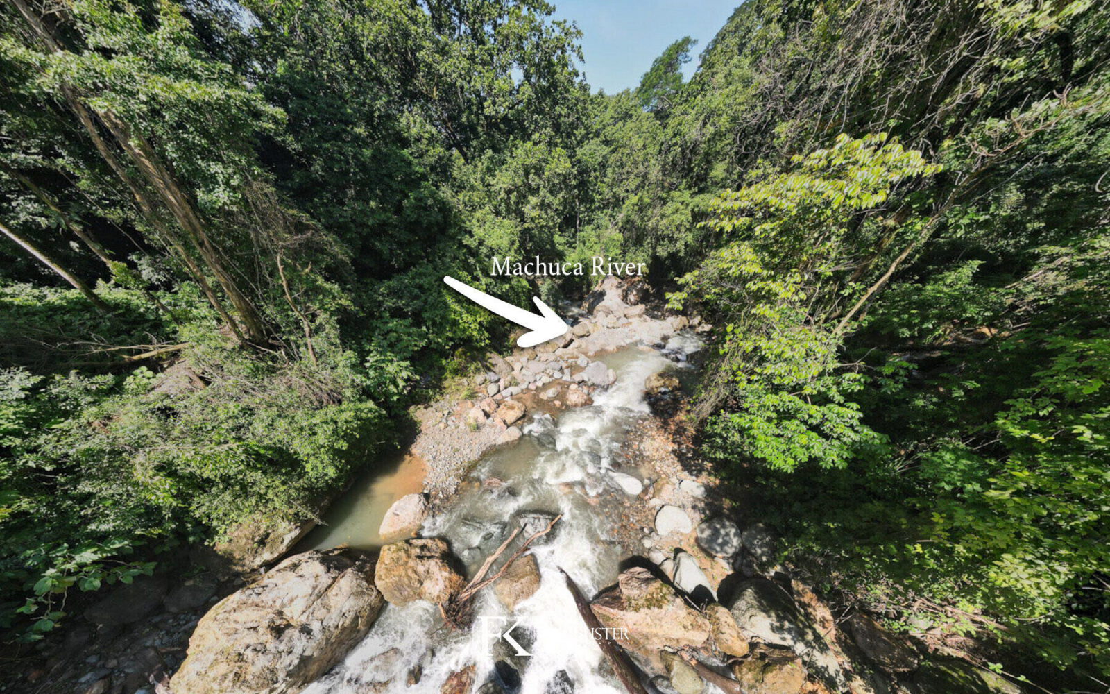 The Machuca River tumbling over rocks between forested banks