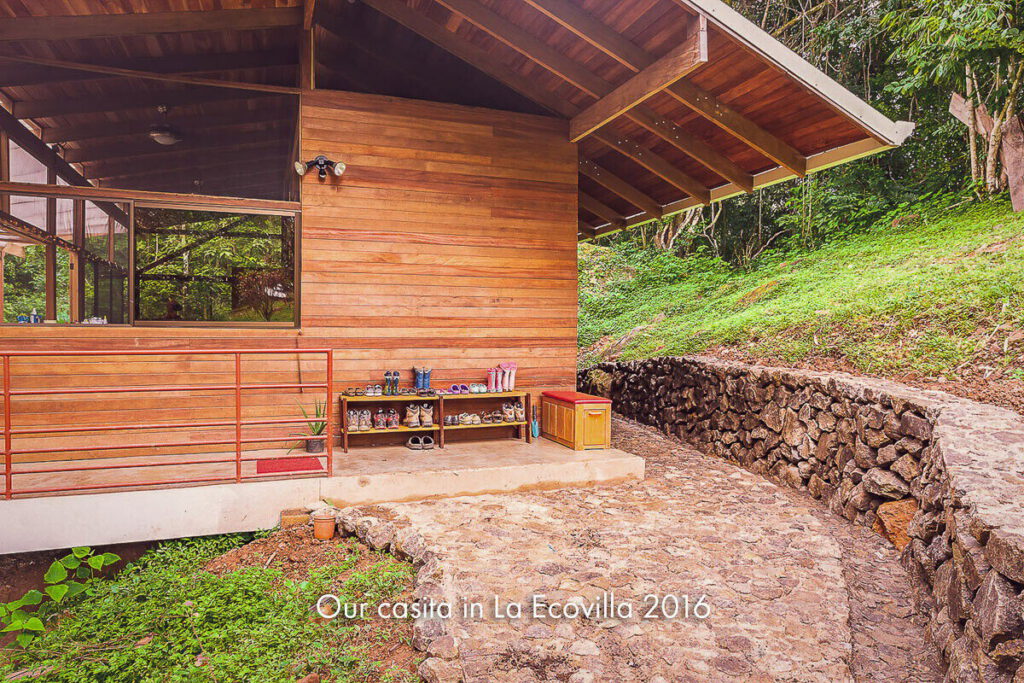 A small timber casita behind a dry-stone retaining wall