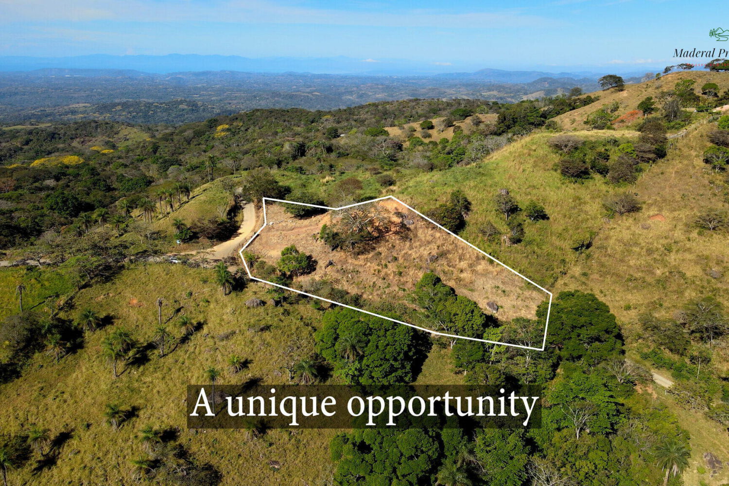 Aerial view of the ridge-top parcel outlined on the hilltop