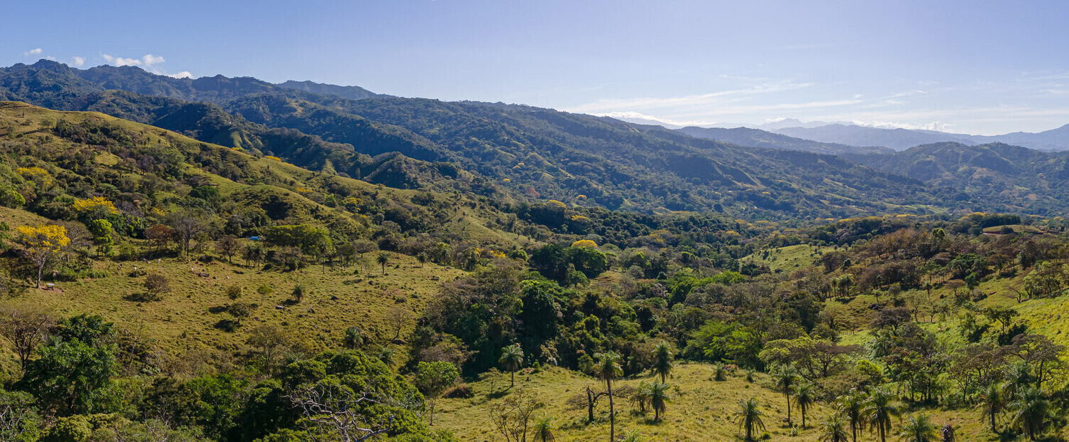 Green ridges descending toward the open Machuca Valley