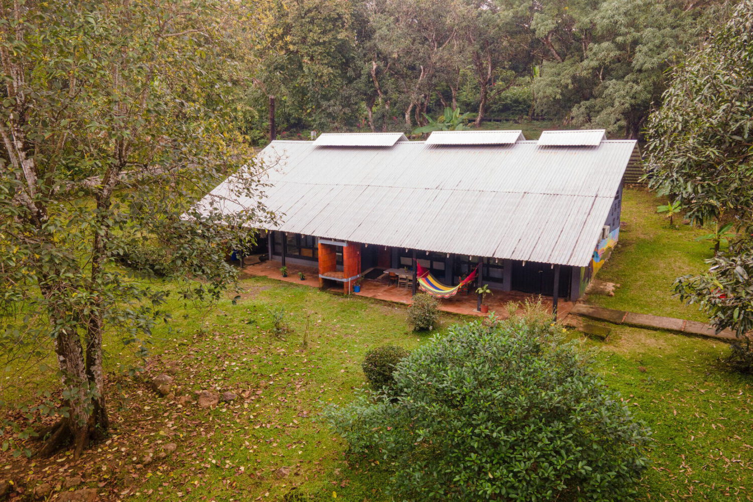 Aerial view of the main building set among mature trees and open lawn